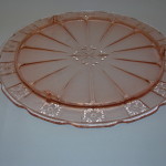 pink depression glass cake plate in Doric pattern